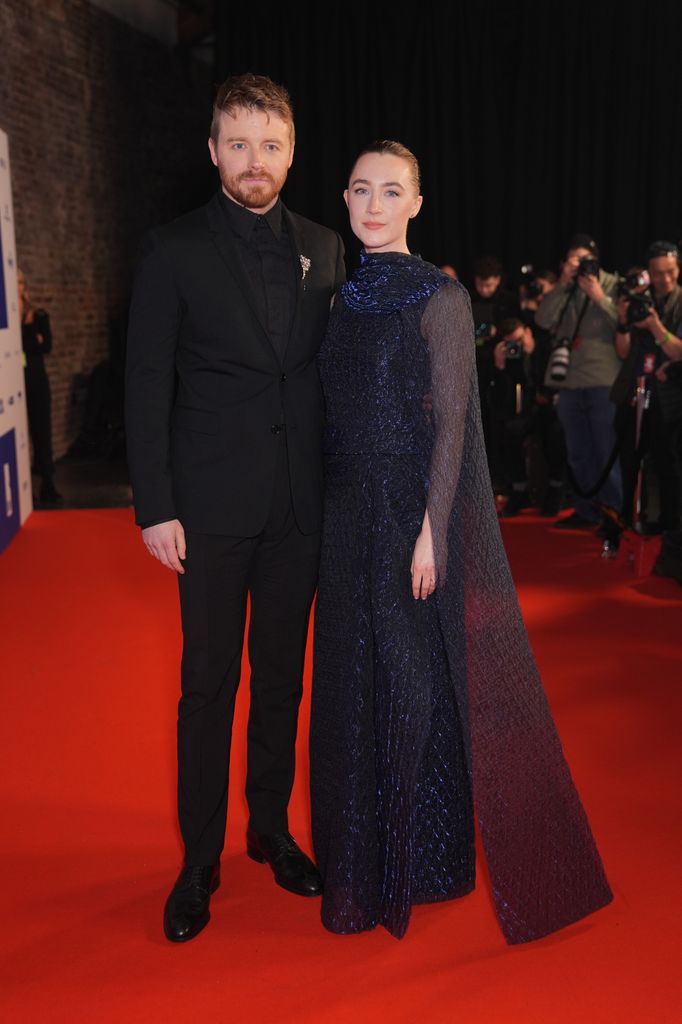 couple posing on red carpet