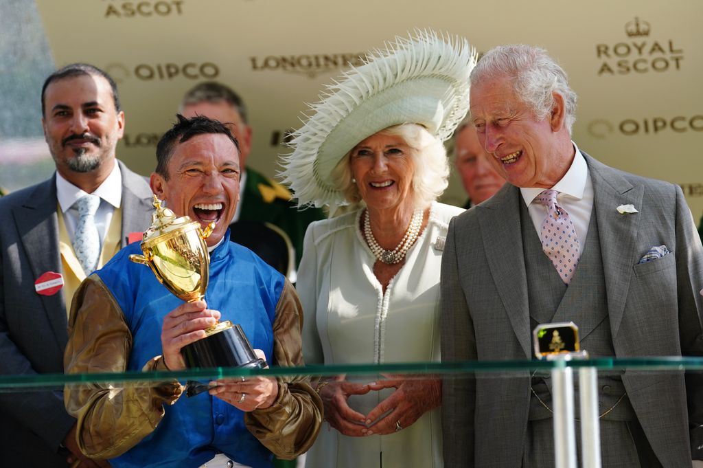 Frankie Dettori celebrates with the trophy, alongside King Charles III and Queen Camilla, Royal Ascot