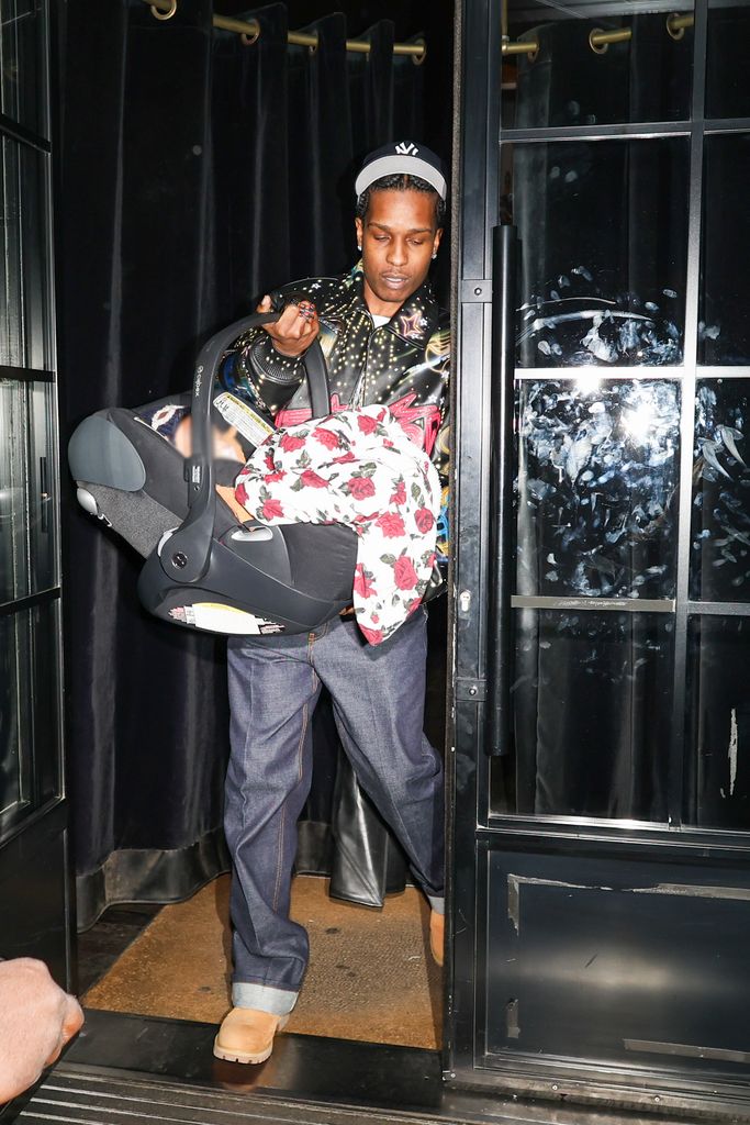 A$AP Rocky carries his daughter Riot Rose in paris