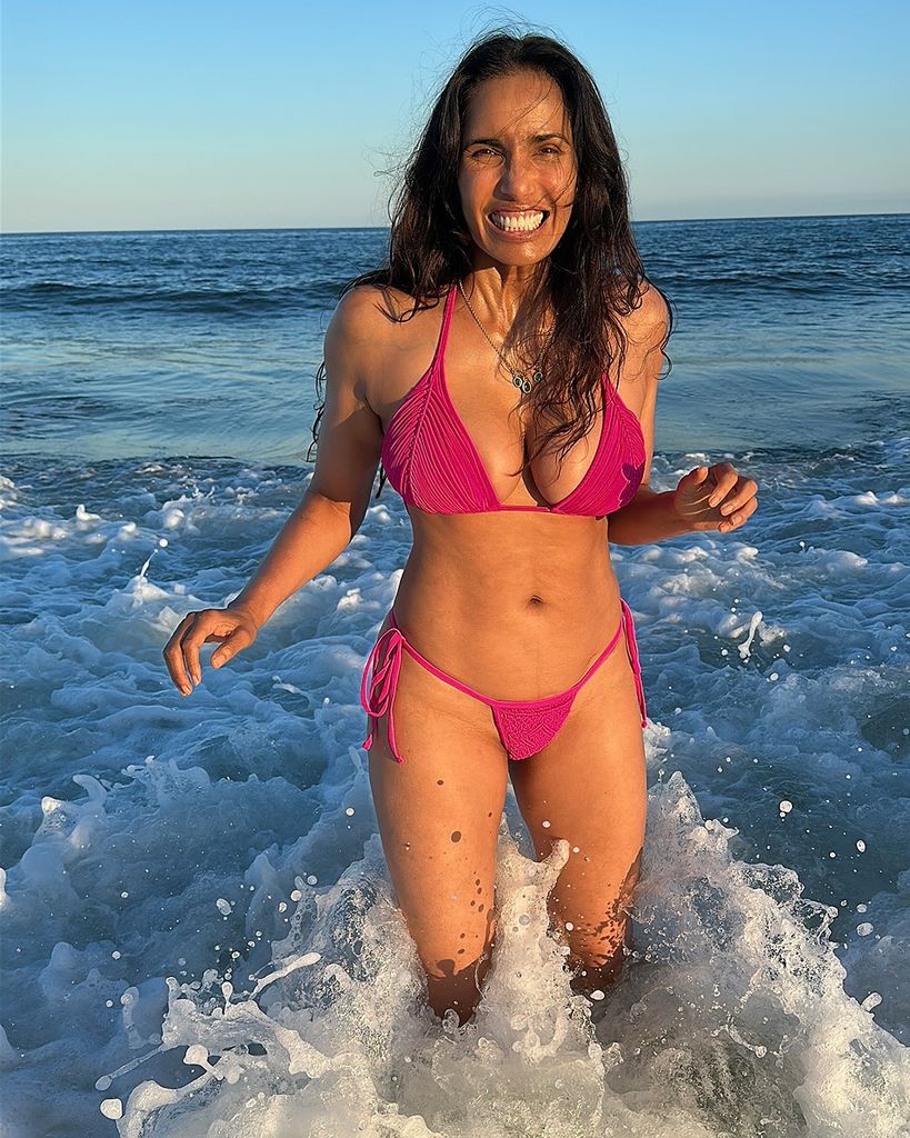 photo of padma lakshmi wearing pink bikini in the sea