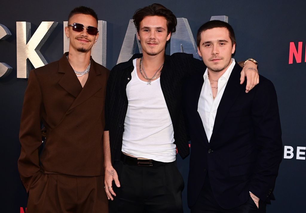 Romeo, Cruz and Brooklyn Beckham standing together