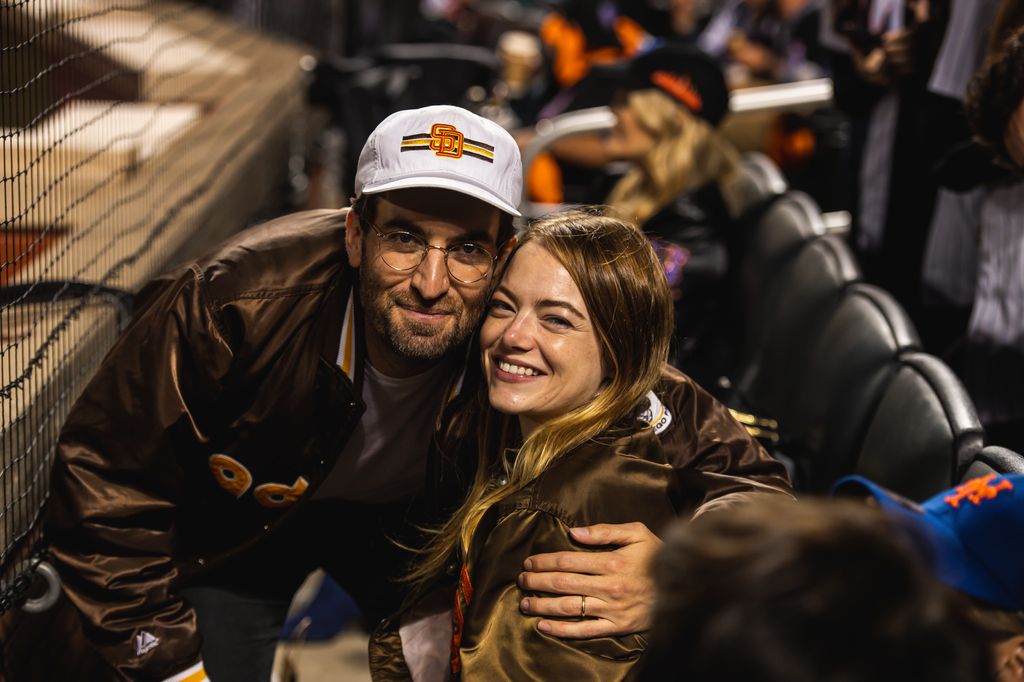 Emma Stone and her husband Dave McCary pose for photo as the San Diego Padres face against the New York Mets in Game One of the Wild Card Series at Citi Field on October 7, 2022 in New York