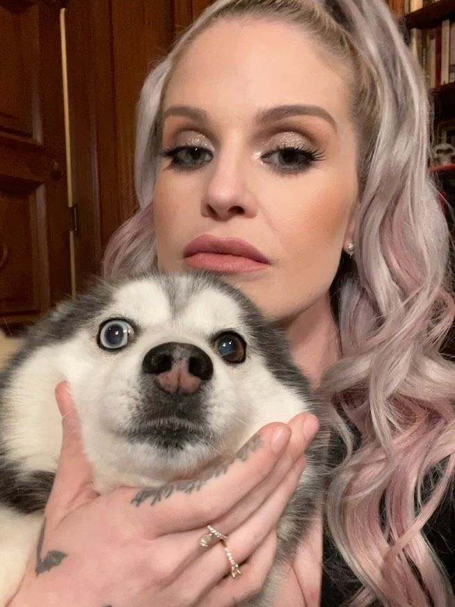 A fully glam Kelly Osbourne cuddles her dog Elvis in a video shared on Instagram