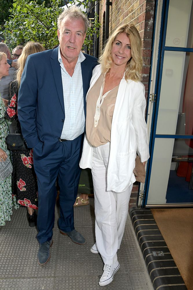 Lisa Hogan wearing a white suit and Jeremy Clarkson in a navy suit