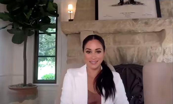 meghan markle sat in front of stone fireplace in home office