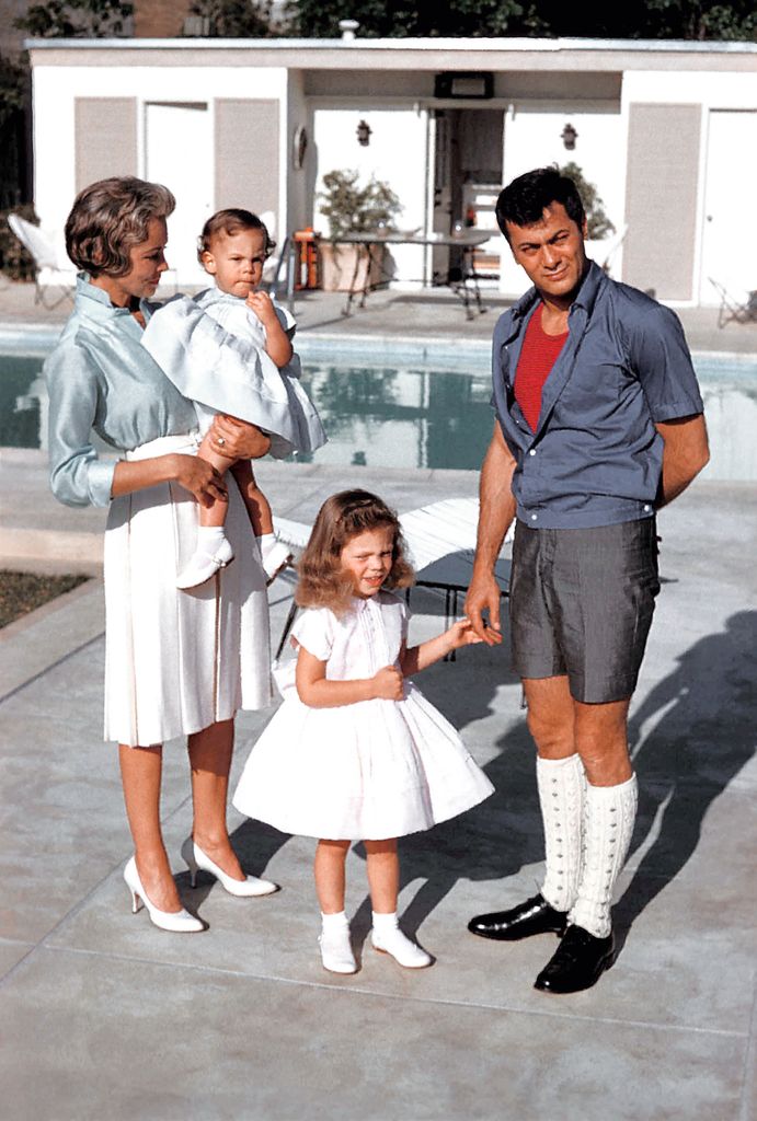Actors Janet Leigh and Tony Curtis play with their daughters