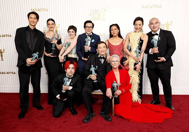 The cast of Everything Everywhere All At Once with their SAG awards on the red carpet