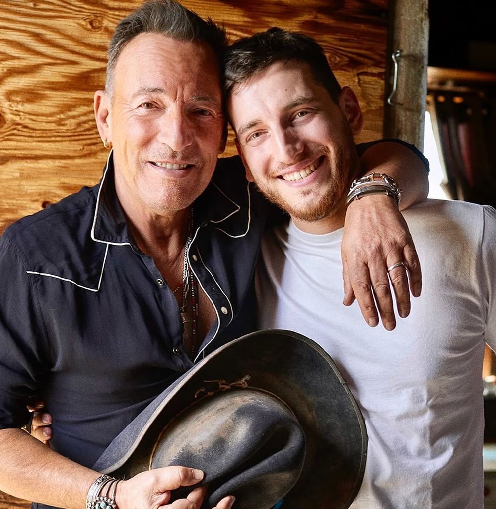 Bruce Springsteen with his arm around son, Samuel Springsteen smiling