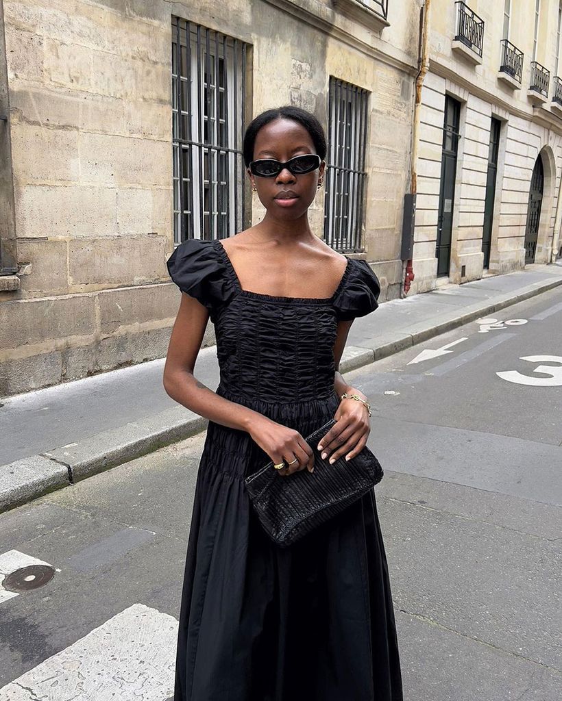 Fashion stylish Sylvie Mus wearing a shopdoen dress in Paris with sunglasses