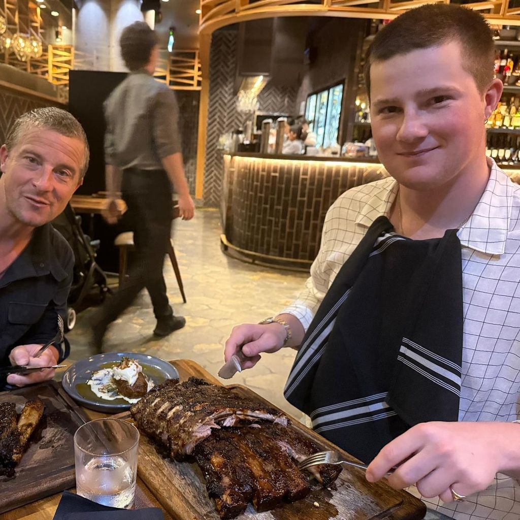 father and son eating plates of ribs 