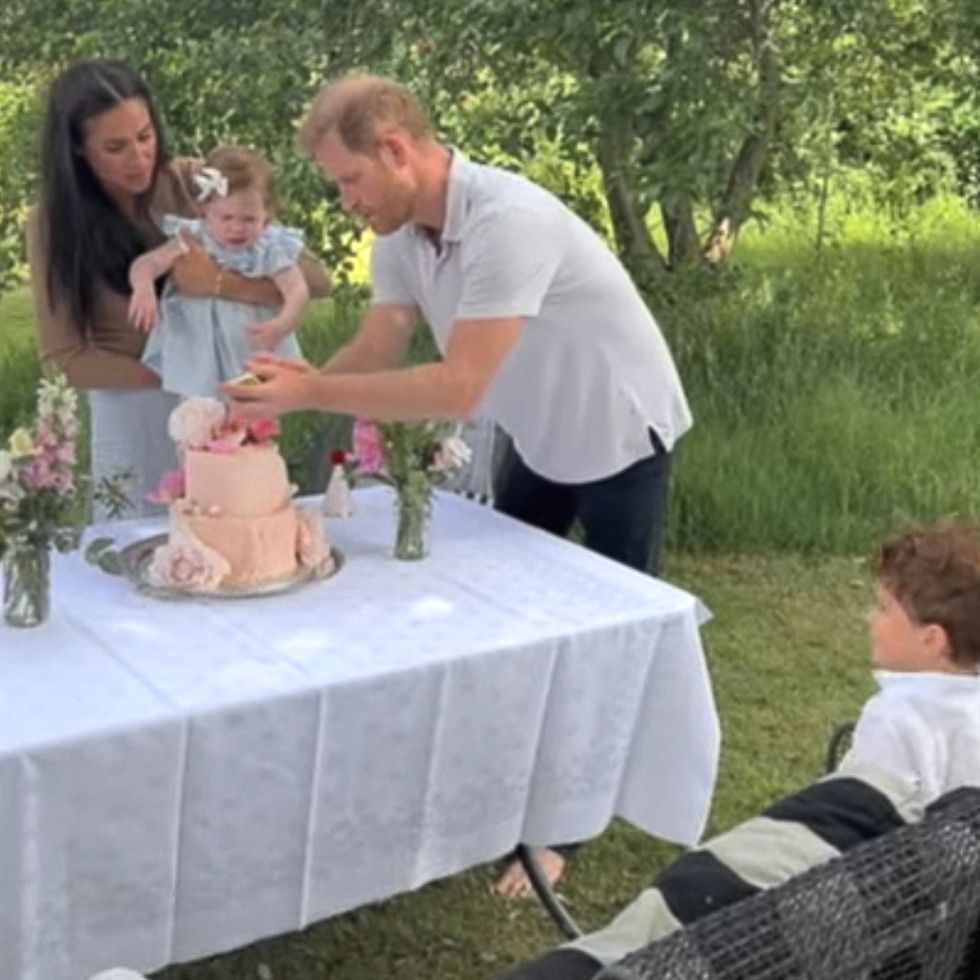 Prince Harry seen lighting the candle on his daughter's first birthday cake