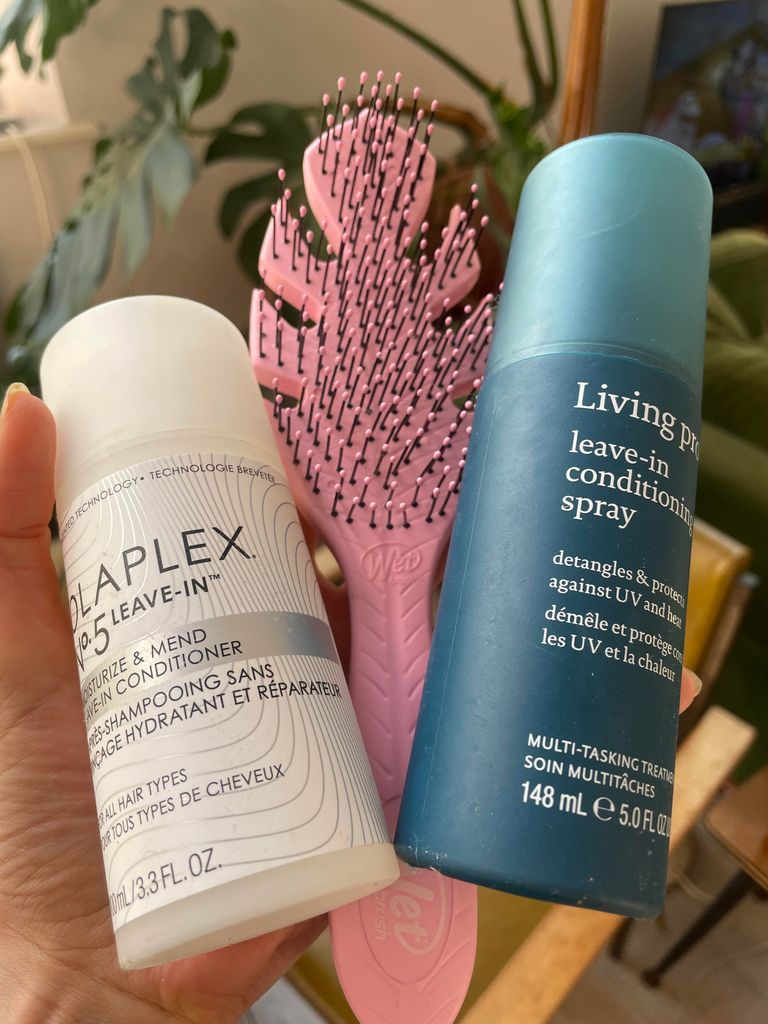 three beauty products held in a hand 