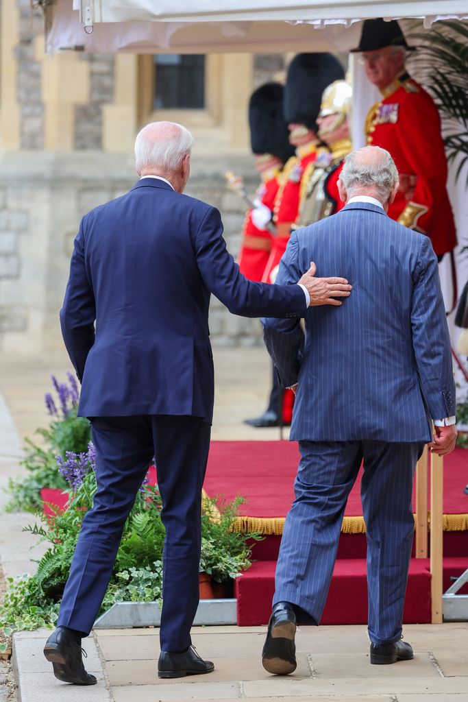US President Joe Biden pats King Charles on the back