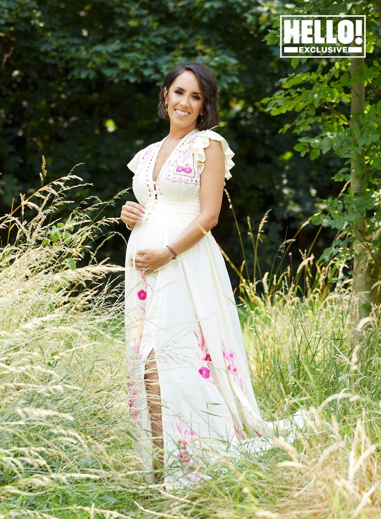 Strictly star Janette Manrara cradling baby bump wearing white embroidered dress