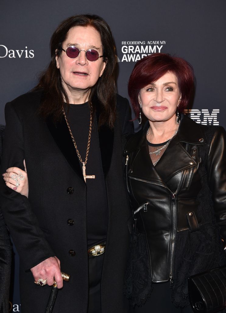 Ozzy Osbourne and Sharon Osbourne with their arms around each other both wearing black