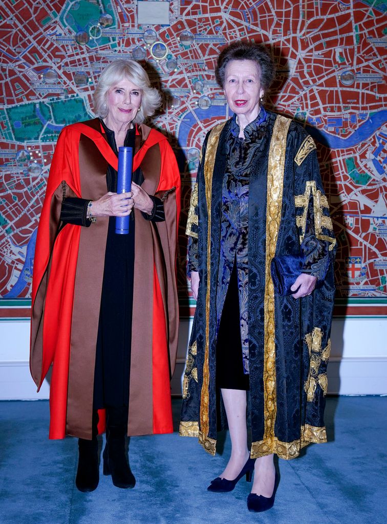 Queen Camilla is presented with an honorary doctorate of literature from the University of London by the University's Chancellor, Princess Anne, Princess Royal