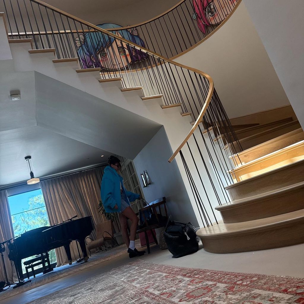 entryway with grand staircase and piano