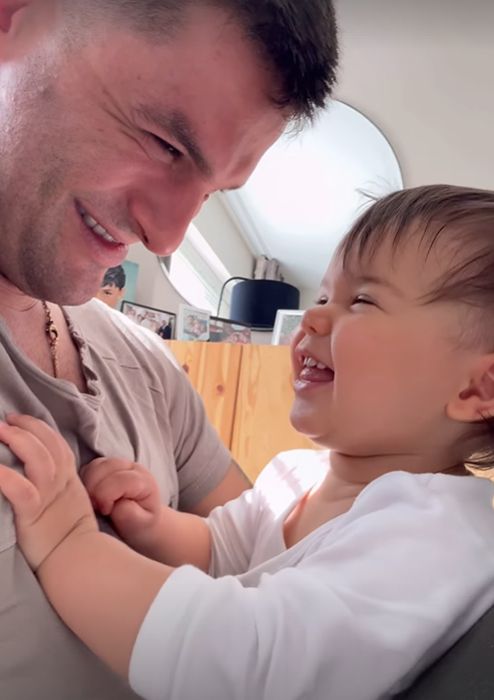 Aljaz Skorjanec and his young daughter smiling at each other