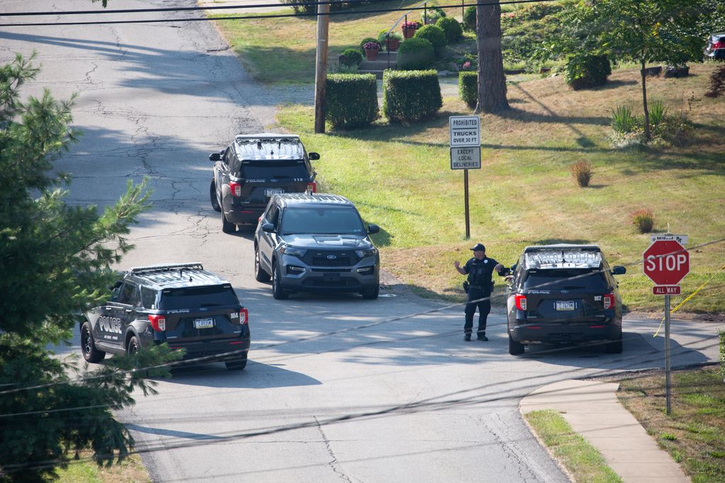 Local police block off roads surrounding the home of the suspected shooter of former US President Donald Trump, as the FBI carries out an investigation, in Bethel Park, Pennsylvania on July 14, 2024