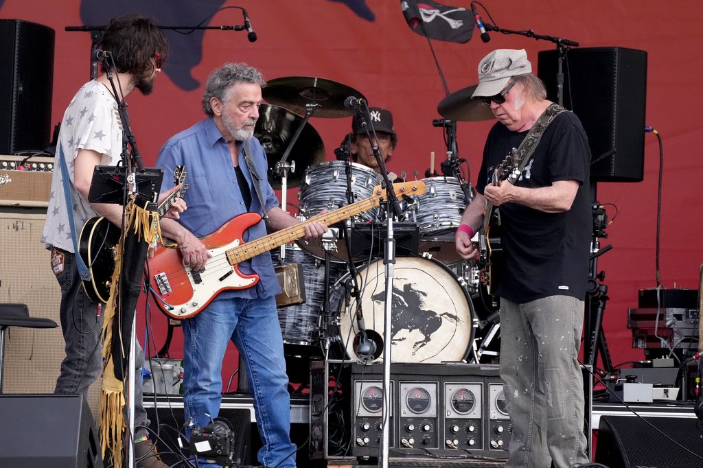 Micah Nelson, Billy Talbot, Ralph Molina, and Neil Young of Crazy Horse perform onstage during the 2024 New Orleans Jazz & Heritage Festival at Fair Grounds Race Course on May 04, 2024 in New Orleans, Louisiana.