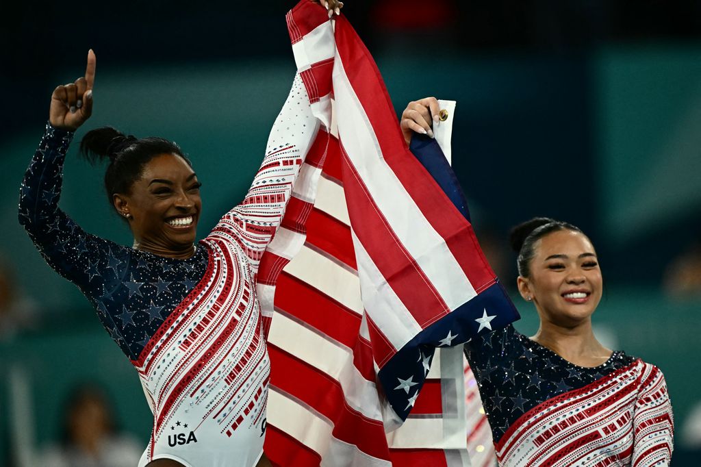 US' Simone Biles (L) and US' Sunisa Lee (R) celebrate after team USA won the artistic gymnastics women's team final during the Paris 2024 Olympic Games at the Bercy Arena in Paris, on July 30, 2024.