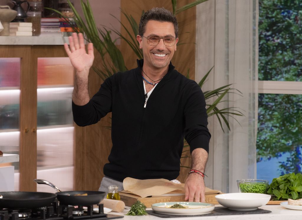 Gino D'Acampo waves as he cooks on This Morning