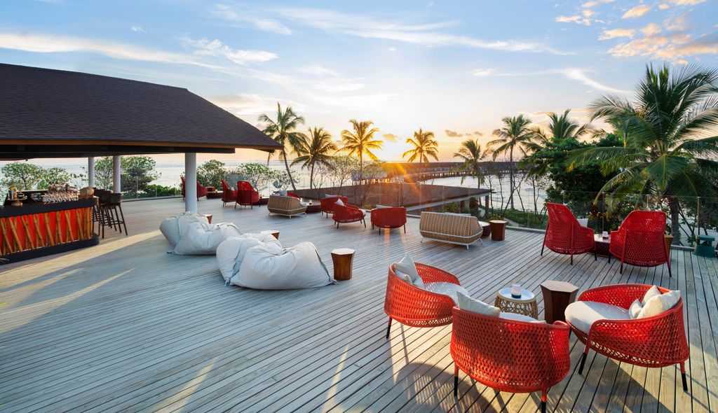 deck terrace with red chairs and palm trees