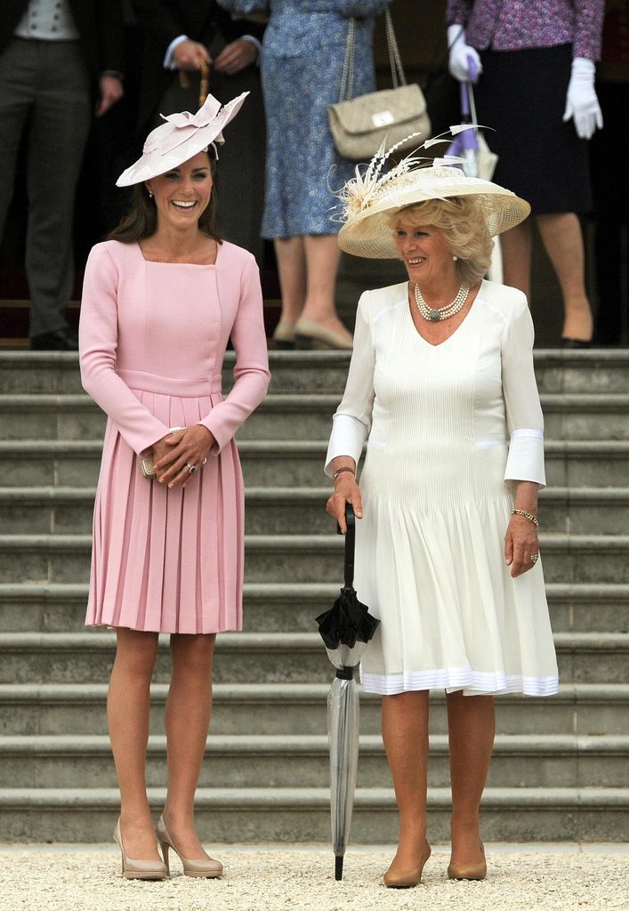 Princess Kate in a pink pleated dress with Queen Camilla