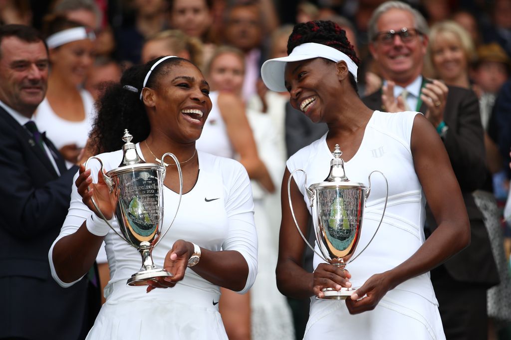 Venus Williams of The United States and Serena Williams of The United States hold their trophies following victory in the Ladies Doubles Final against Timea Babos of Hungary and Yaroslava Shvedova of Kazakhstan on day twelve of the Wimbledon Lawn Tennis Championships at the All England Lawn Tennis and Croquet Club on July 9, 2016 in London, England.