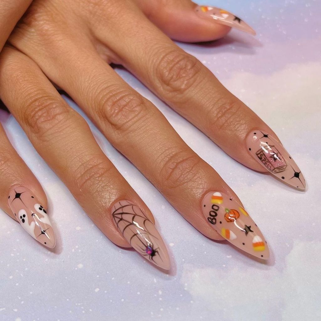 Each nail tells its own story, from ghosts to candy corn and spider webs, all on a nude base. The detailed art and variety make these nails a festive and fun choice for the Halloween season.