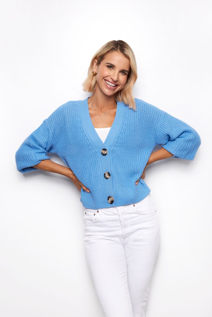 Vogue Williams wearing white skinny jeans and blue cardigan