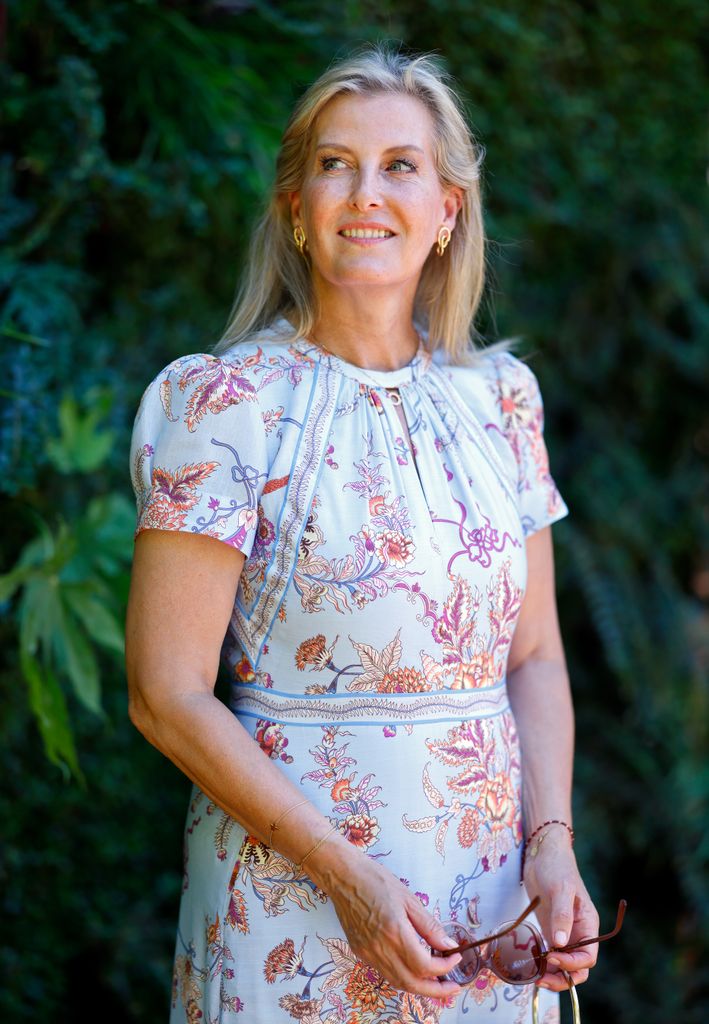 Sophie, Duchess of Edinburgh by living wall in blue patterned dress