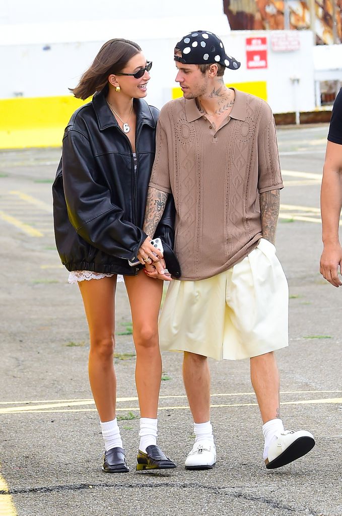 Hailey Bieber and Justin Bieber facing eachother walking