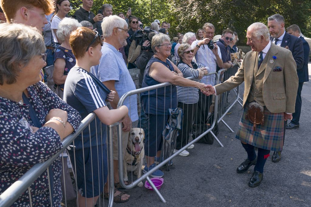 King Charles greets the public outside the gates to Balmoral