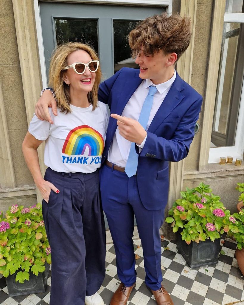 Victoria Derbyshire wearing a Thank You T-shirt with her suit-clad son