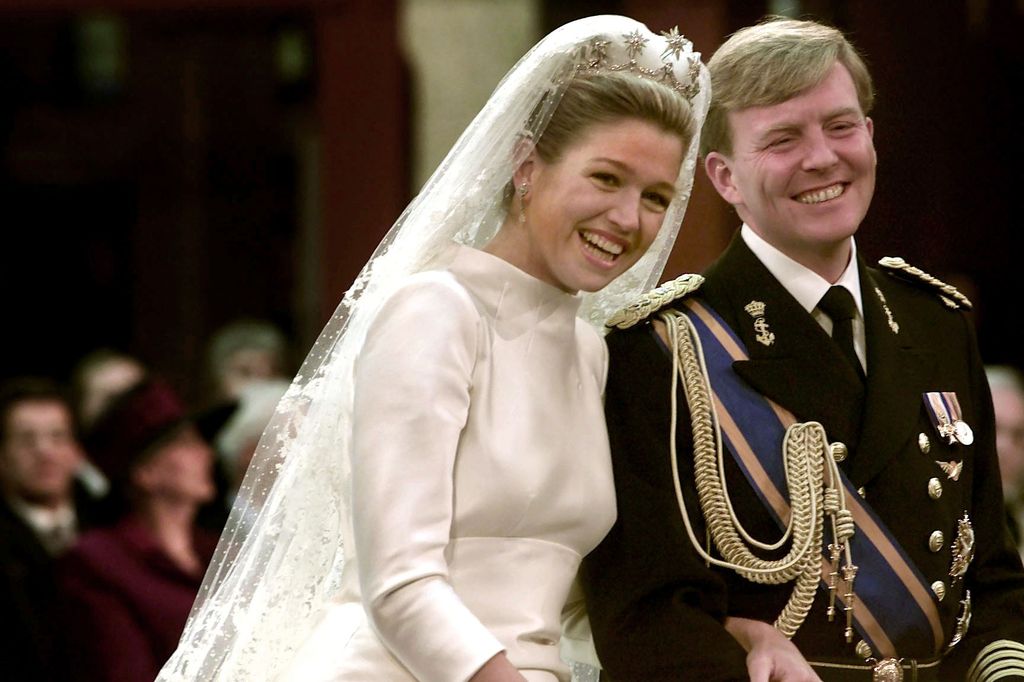 Prince Willem-Alexander and Maxima smiling at altar