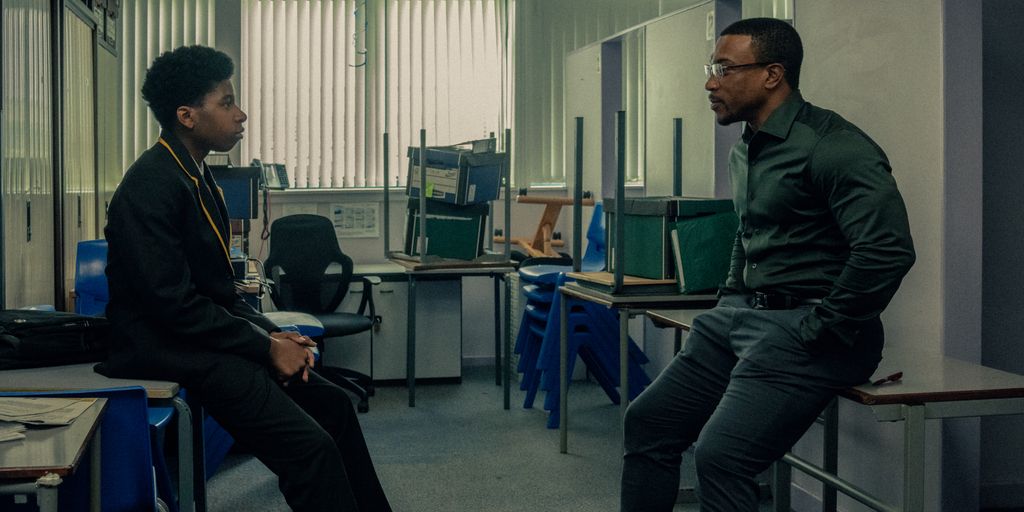 Amari Jayden Bacchus as Adam Bascombe, Ashley Walters as Detective Inspector Bascome, in Adolescence