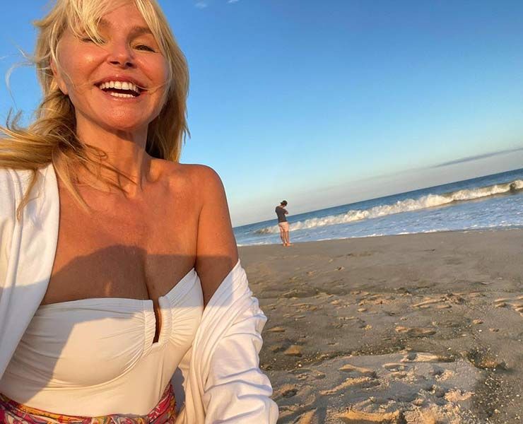 christie brinkley white swimsuit beach
