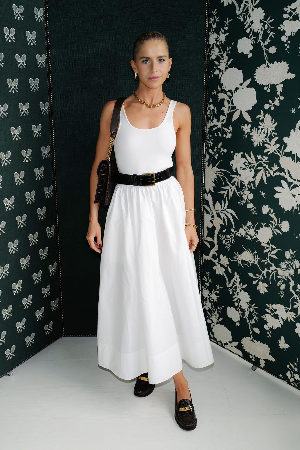 Caroline Daur looked magnificent in monochrome, wearing a white pleated skirt with a vest tucked in, a black wait belt, a black and gold shoulder bag and penny loafers.