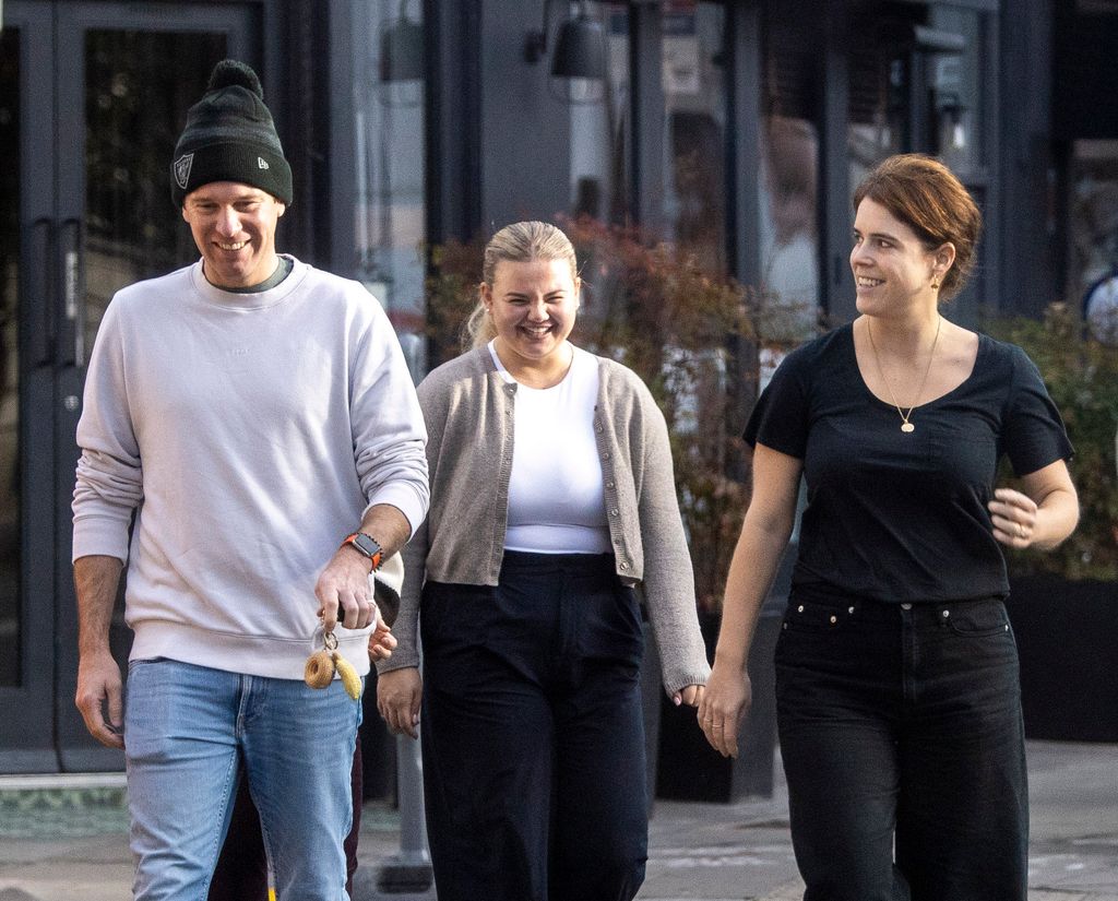 Jack Brooksbank walking with Princess Eugenie and a woman