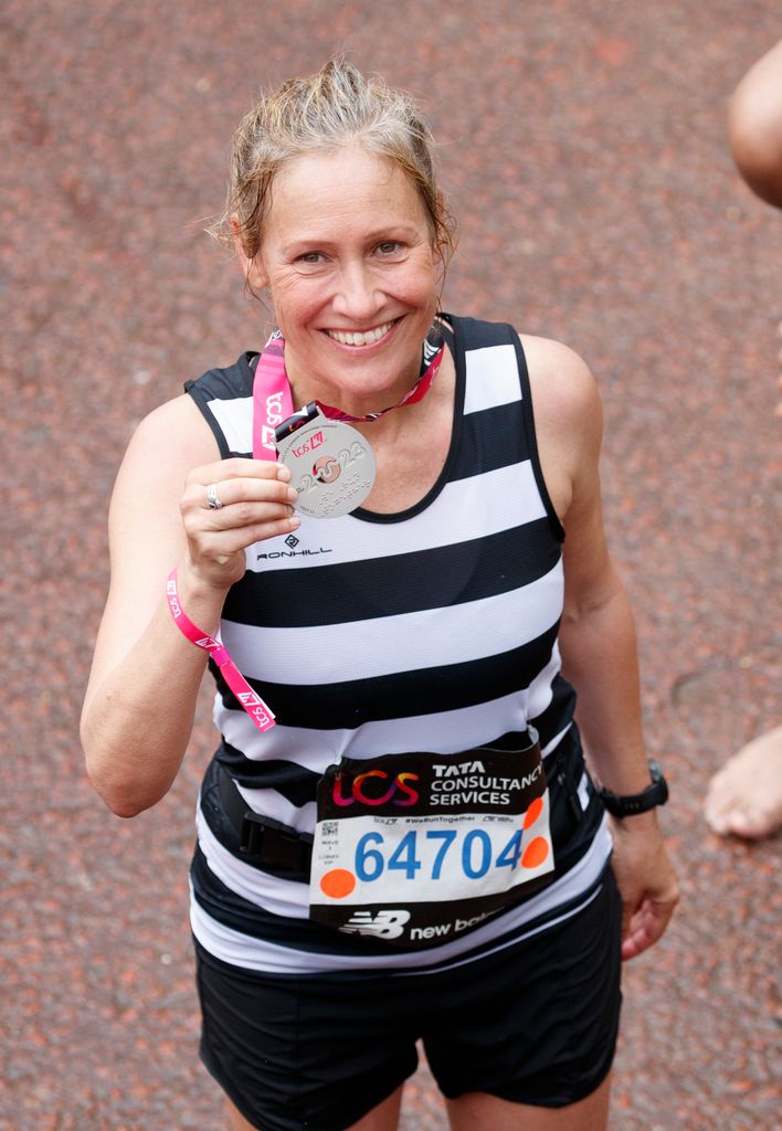 Sophie Raworth holding a medal following the London marathon