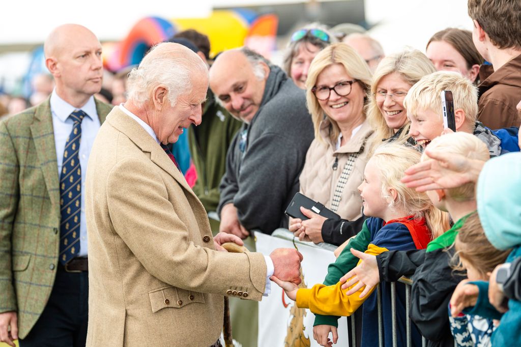 King Charles shaking hands with a crowd