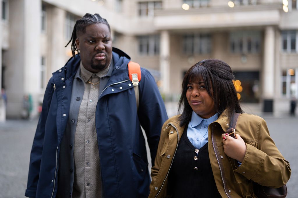 man and woman walking in street