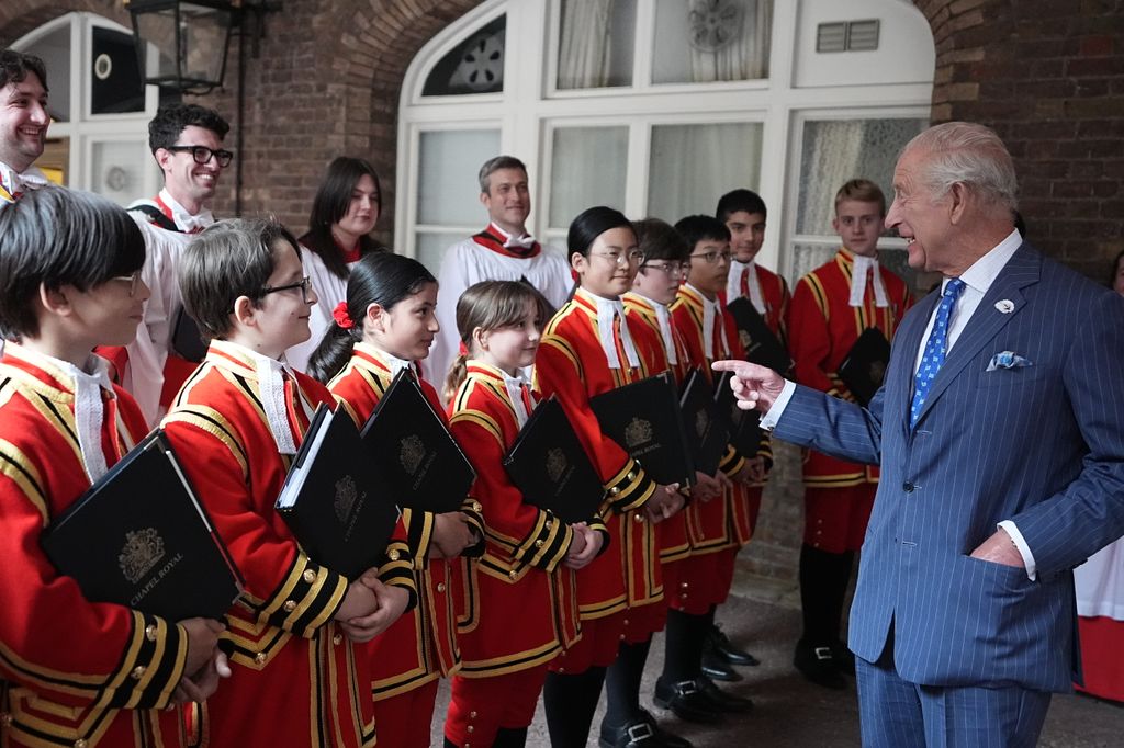 King Charles III meeting choristers after a service celebrating 400 years of The Queen's Chapel