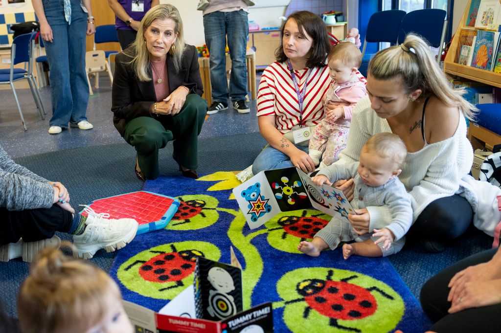 Sophie crouching on ladybird rug with mothers and babies