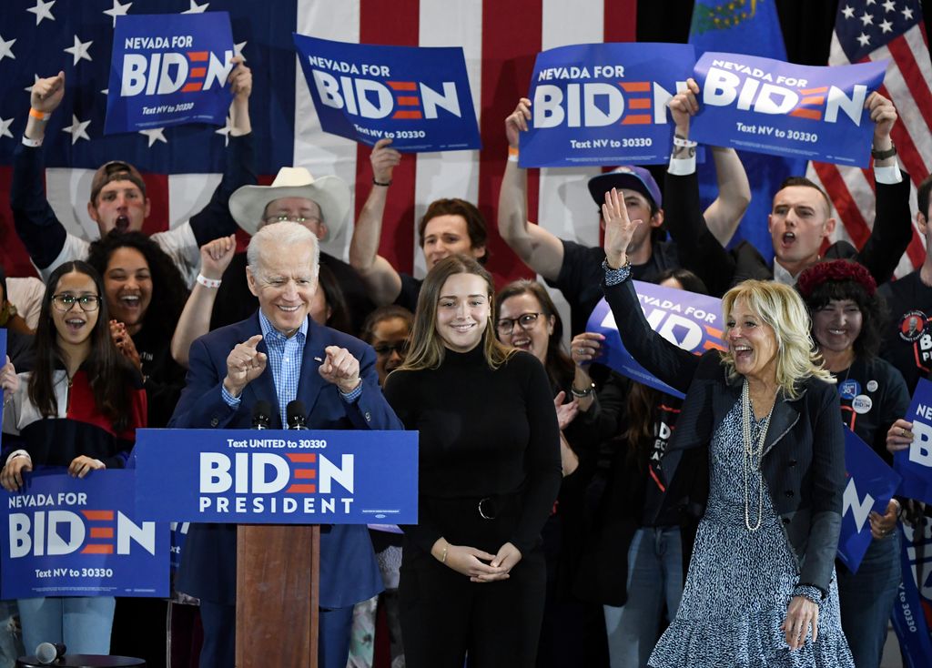 Joe Biden (L), his wife Dr. Jill Biden (R) and their granddaughter Finnegan Biden (C) are greeted as they arrive at a Nevada caucus day event 