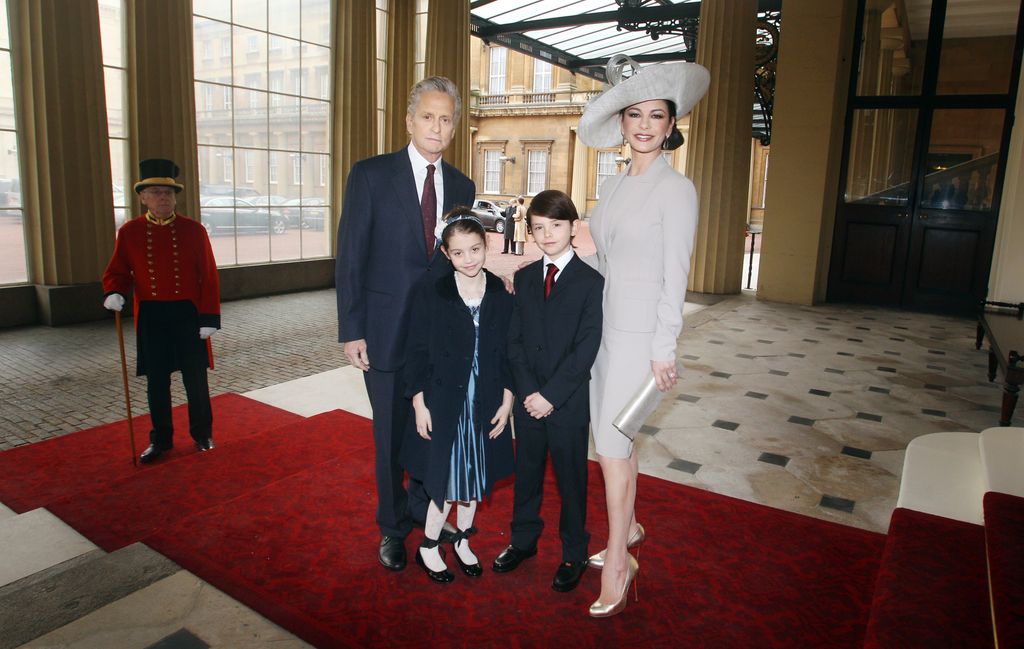 Catherine Zeta-Jones, her husband Michael Douglas and their children inside Buckingham Palace