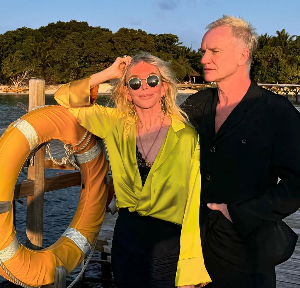 Sting and Trudie Styler stand on a jetty at sunset in the Maldives