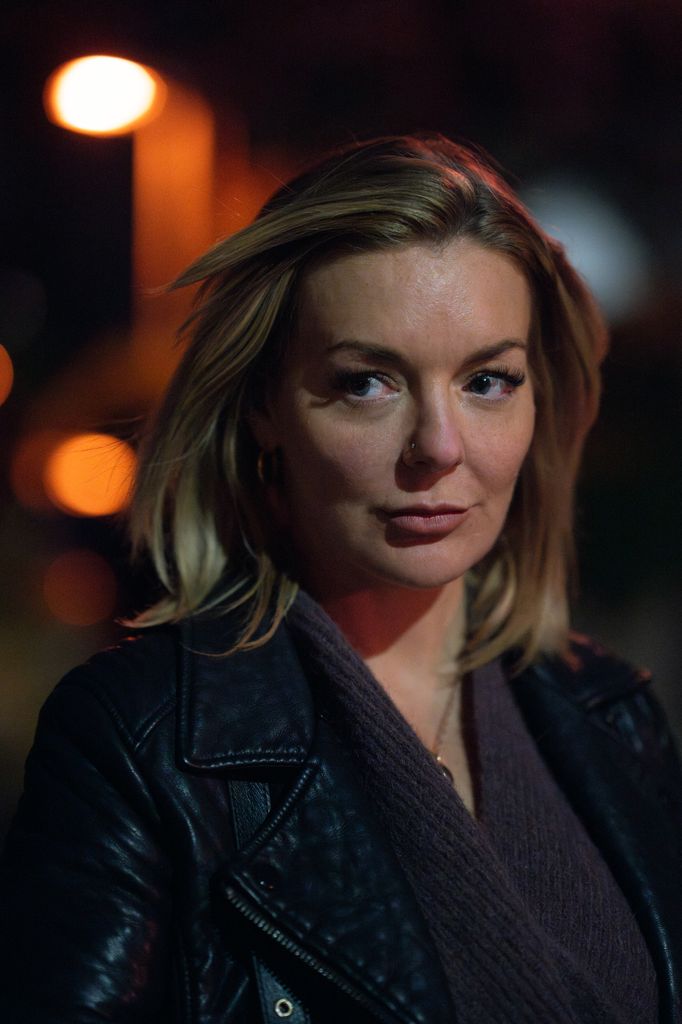 close-up of blonde woman in dark street