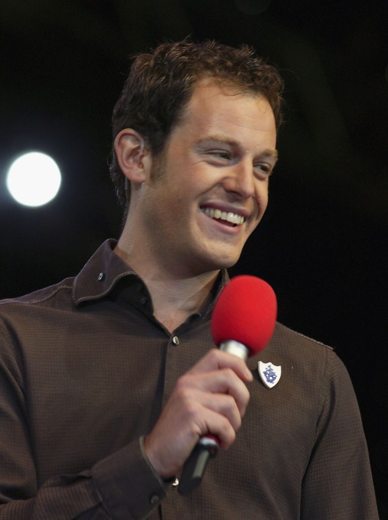LEATHERHEAD, ENGLAND - SEPTEMBER 11:  Matt Baker of Blue Peter hosst on stage at the BBC Family Prom In The Park on September 11, 2005 in London, England. The musical journey marks the centenary of Jules Verne's Around The World In 80 Days and succeeds yesterday's Last Night Of The Proms. (Photo by Jo Hale/Getty Images) 
